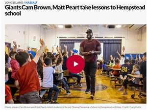 Giants Cam Brown takes lesson to Hempstead school article with image of man in school auditorium